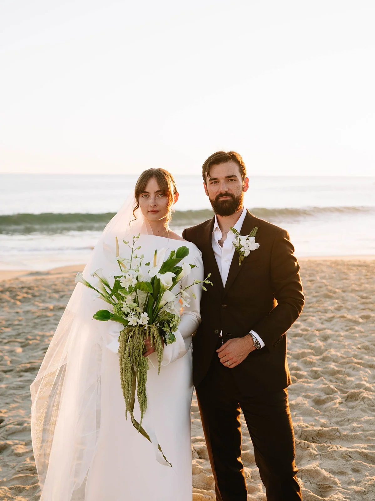 Wedding couple in Laguna Beach with florals